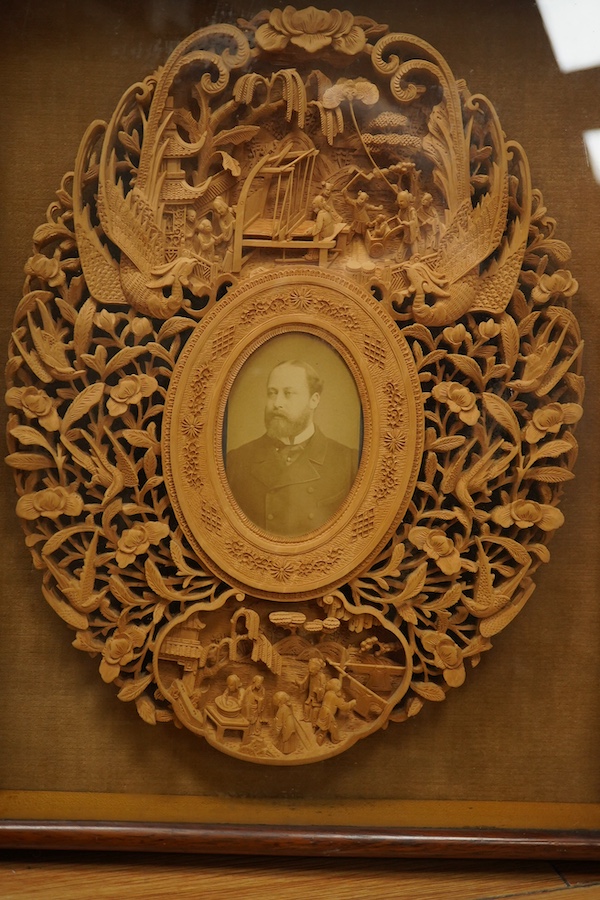 A pair of early 20th century, finely carved Chinese sandalwood photo frames, 30.5cmx24cm oval. Condition - good